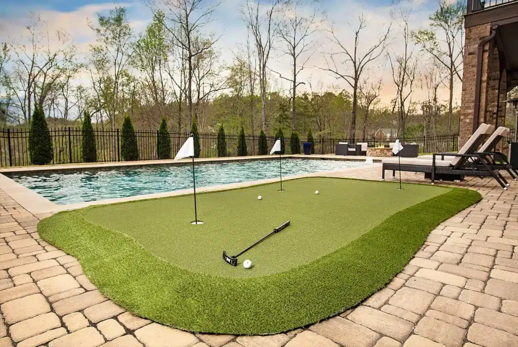 Backyard golf green pool area installed by SYNLawn